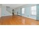 Spacious living room featuring hardwood floors, large windows with floral curtains, and vintage trim at 535 22Nd N Ave, St Petersburg, FL 33704