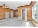 Spacious Living Room with wood paneling, vintage ceiling fan, built-ins, and view to bathroom at 535 22Nd N Ave, St Petersburg, FL 33704