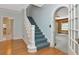 Elegant staircase with blue carpet runner, light blue walls, and wooden floors at 535 22Nd N Ave, St Petersburg, FL 33704
