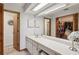 Bright bathroom features a vanity, mirror, and closet, providing a functional space for daily routines at 5633 99Th N Ter, Pinellas Park, FL 33782