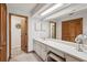Long vanity offers ample counter space, storage, and mirrors in this light-filled bathroom at 5633 99Th N Ter, Pinellas Park, FL 33782