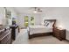 Spacious bedroom featuring light walls, wood dresser, and windows to the backyard at 5633 99Th N Ter, Pinellas Park, FL 33782