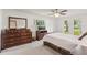Sun-filled bedroom features light walls, wood dresser, and windows to the backyard at 5633 99Th N Ter, Pinellas Park, FL 33782