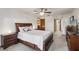 Bright bedroom has light walls, wood dresser, and backyard window views at 5633 99Th N Ter, Pinellas Park, FL 33782