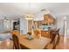 Open-concept dining area connected to the kitchen with stylish lighting at 5633 99Th N Ter, Pinellas Park, FL 33782