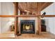 Close-up of fireplace and tile work with wood beam accent at 5633 99Th N Ter, Pinellas Park, FL 33782