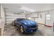 Spacious garage with a blue sports car, storage cabinets, and a door, providing ample parking and storage at 5633 99Th N Ter, Pinellas Park, FL 33782