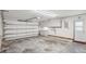 Clean garage with white walls, a roll-up door, cabinets, and a door, providing storage and utility at 5633 99Th N Ter, Pinellas Park, FL 33782