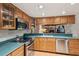 Well-maintained kitchen with stainless appliances, wood cabinetry, and green countertops at 5633 99Th N Ter, Pinellas Park, FL 33782