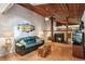 Cozy living room with fireplace, wood beam ceiling, and views into the kitchen area at 5633 99Th N Ter, Pinellas Park, FL 33782