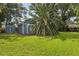 Image features two blue sheds on a spacious lawn surrounded by trees, offering ample outdoor storage at 5633 99Th N Ter, Pinellas Park, FL 33782