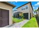 Backyard showcasing a screened patio, manicured lawn, and pathway to the house at 5831 Caldera Ridge Dr, Lithia, FL 33547