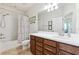 Bathroom featuring a shower-tub combo, single vanity, and wood cabinets at 5831 Caldera Ridge Dr, Lithia, FL 33547