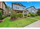Charming two-story home showcasing a covered porch, manicured lawn, and vibrant landscaping at 5831 Caldera Ridge Dr, Lithia, FL 33547