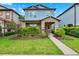 Charming two-story home showcasing a covered porch, manicured lawn, and vibrant landscaping at 5831 Caldera Ridge Dr, Lithia, FL 33547