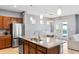 A kitchen with stainless steel appliances, a large island, and a view of the dining area at 5831 Caldera Ridge Dr, Lithia, FL 33547