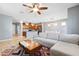 Open-concept living space with tile flooring, a comfortable sofa, and a view into the kitchen at 5831 Caldera Ridge Dr, Lithia, FL 33547