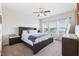 Bright bedroom featuring a ceiling fan, carpet flooring, and large windows with natural light at 5831 Caldera Ridge Dr, Lithia, FL 33547