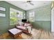 Stylish home office with green walls, wood floors, and modern furniture at 5831 Caldera Ridge Dr, Lithia, FL 33547
