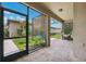 View of a screened in patio with pavers, a hammock, and a small garden with lush greenery at 5831 Caldera Ridge Dr, Lithia, FL 33547