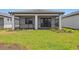 A well-maintained backyard with a screened lanai provides a private outdoor space for relaxation at 6133 Wire Grass Ct, Nokomis, FL 34275