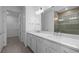 Modern bathroom boasting double sinks, walk-in shower, and ample storage at 6133 Wire Grass Ct, Nokomis, FL 34275