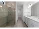 Spa-like bathroom with dual sinks, glass shower, and access to the walk-in closet at 6133 Wire Grass Ct, Nokomis, FL 34275