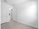 Bedroom with neutral tile floors featuring white doors and trim at 6133 Wire Grass Ct, Nokomis, FL 34275