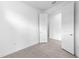 Neutral bedroom with tile floors featuring white doors and trim at 6133 Wire Grass Ct, Nokomis, FL 34275