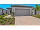 Charming single Gathering home featuring a two-car garage and beautifully landscaped front yard at 6133 Wire Grass Ct, Nokomis, FL 34275