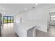 Bright kitchen featuring white cabinetry, stainless steel appliances, and a center island at 6133 Wire Grass Ct, Nokomis, FL 34275