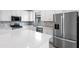 Bright kitchen showcasing quartz countertops, stainless steel appliances, and stylish backsplash at 6133 Wire Grass Ct, Nokomis, FL 34275