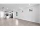 Open floor plan with modern kitchen featuring a center island seamlessly flowing to the living area at 6133 Wire Grass Ct, Nokomis, FL 34275