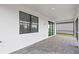 Covered patio area featuring brick pavers, windows, and sliding glass doors at 6133 Wire Grass Ct, Nokomis, FL 34275