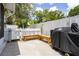 Private backyard features a grill and wooden bench seating, perfect for outdoor entertaining at 615 6Th N Ave, Safety Harbor, FL 34695