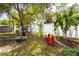 Backyard featuring mature landscaping, a playhouse, saucer swing, white privacy fence, and outdoor seating at 615 6Th N Ave, Safety Harbor, FL 34695