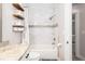 Bathroom features a tub with white tile surround and decorative shelves at 615 6Th N Ave, Safety Harbor, FL 34695