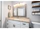 Bathroom features a vanity with granite countertop and a decorative framed mirror at 615 6Th N Ave, Safety Harbor, FL 34695