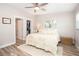 Comfortable bedroom with wood floors, natural light, neutral bedding, and a closet for ample storage at 615 6Th N Ave, Safety Harbor, FL 34695