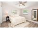 Cozy bedroom featuring wood floors, light walls, neutral bedding, and large windows offering natural light at 615 6Th N Ave, Safety Harbor, FL 34695