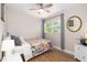 Cozy bedroom with bright window, quilt-covered bed, and decorative mirror at 615 6Th N Ave, Safety Harbor, FL 34695
