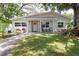 Charming single-story home with a well-manicured lawn and inviting front porch at 615 6Th N Ave, Safety Harbor, FL 34695