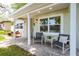 View of the front porch with seating, showing the home's curb appeal and landscaping at 615 6Th N Ave, Safety Harbor, FL 34695