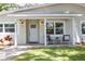 Close-up of covered front porch with seating area and freshly painted exterior at 615 6Th N Ave, Safety Harbor, FL 34695