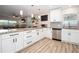 Open kitchen with granite counters, stylish cabinets, and a view into the living area at 615 6Th N Ave, Safety Harbor, FL 34695