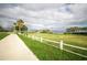 Scenic park featuring a walking path, grassy area, white picket fence, and waterfront views at 615 6Th N Ave, Safety Harbor, FL 34695