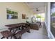 Spacious screened-in patio features a dining table with a view of the backyard at 615 6Th N Ave, Safety Harbor, FL 34695