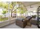 Screened-in patio with ceiling fan and comfortable seating, overlooking a backyard and playhouse at 615 6Th N Ave, Safety Harbor, FL 34695