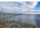 Picturesque waterfront view with a long wooden pier extending into the serene blue water at 615 6Th N Ave, Safety Harbor, FL 34695