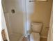 Bathroom featuring a shower stall and toilet, with signs of wear and tear, awaiting remodeling and renovation at 6203 Calamari Pl, Riverview, FL 33578